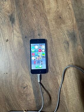 Apple iPhone SE with Black Front and Silver Charger Cable